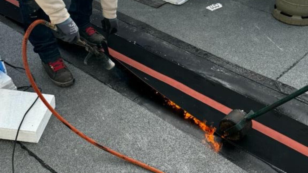 Heating the lower waterproofing membrane with the hand torch