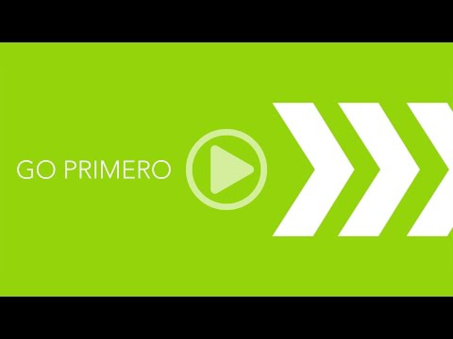 Ein grünes Rechteck mit weißem Text, der GO PRIMERO lautet, ein Symbol für die Wiedergabetaste und drei fette weiße Pfeile, die nach rechts zeigen, auf der rechten Seite. Oben und unten erscheinen schwarze Balken.