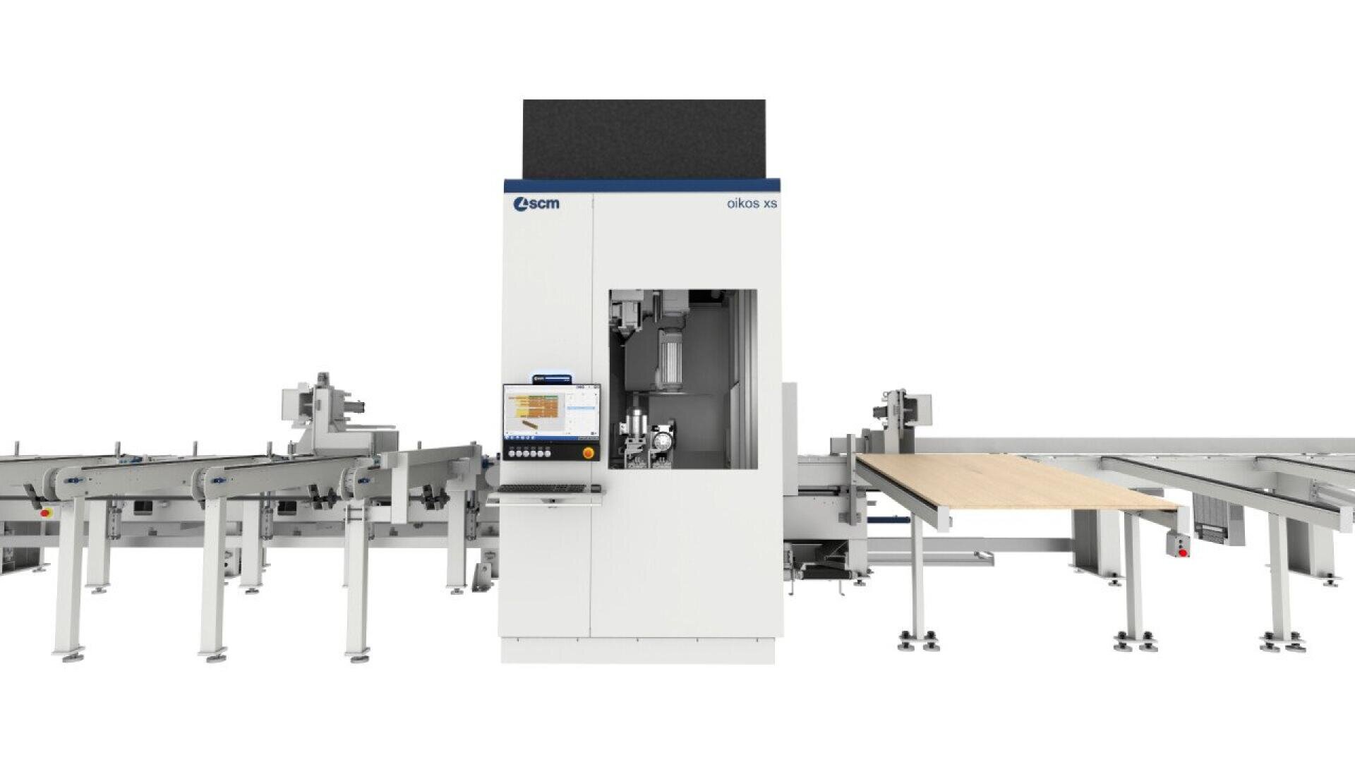 A large, industrial CNC woodworking machine with a central vertical unit, attached touchscreen monitor, and conveyor tables on both sides for material handling, set against a plain white background.