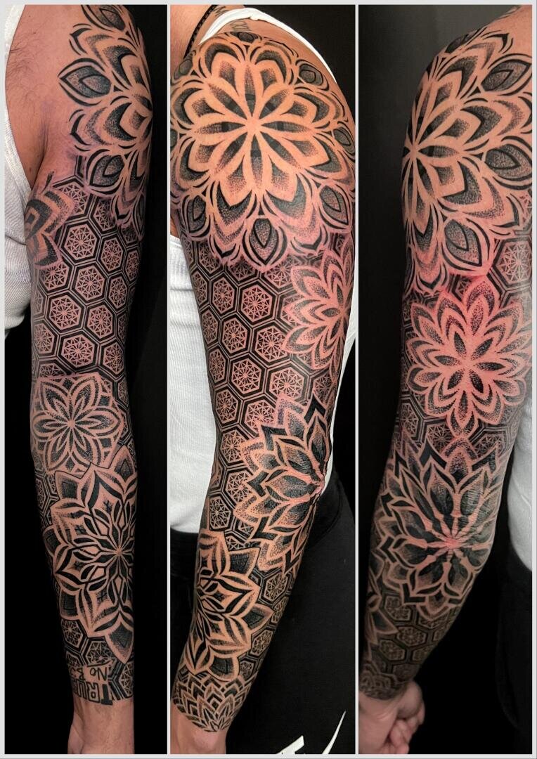 A full arm tattoo with intricate geometric patterns and large mandala-shaped floral designs shown from three different angles on a person's arm.
