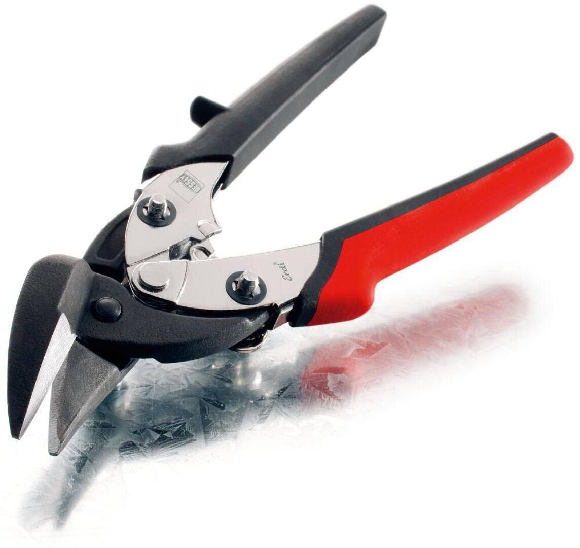 A pair of metal snips with black and red handles, featuring a sharp, angled cutting blade, lying on a sheet of metal.