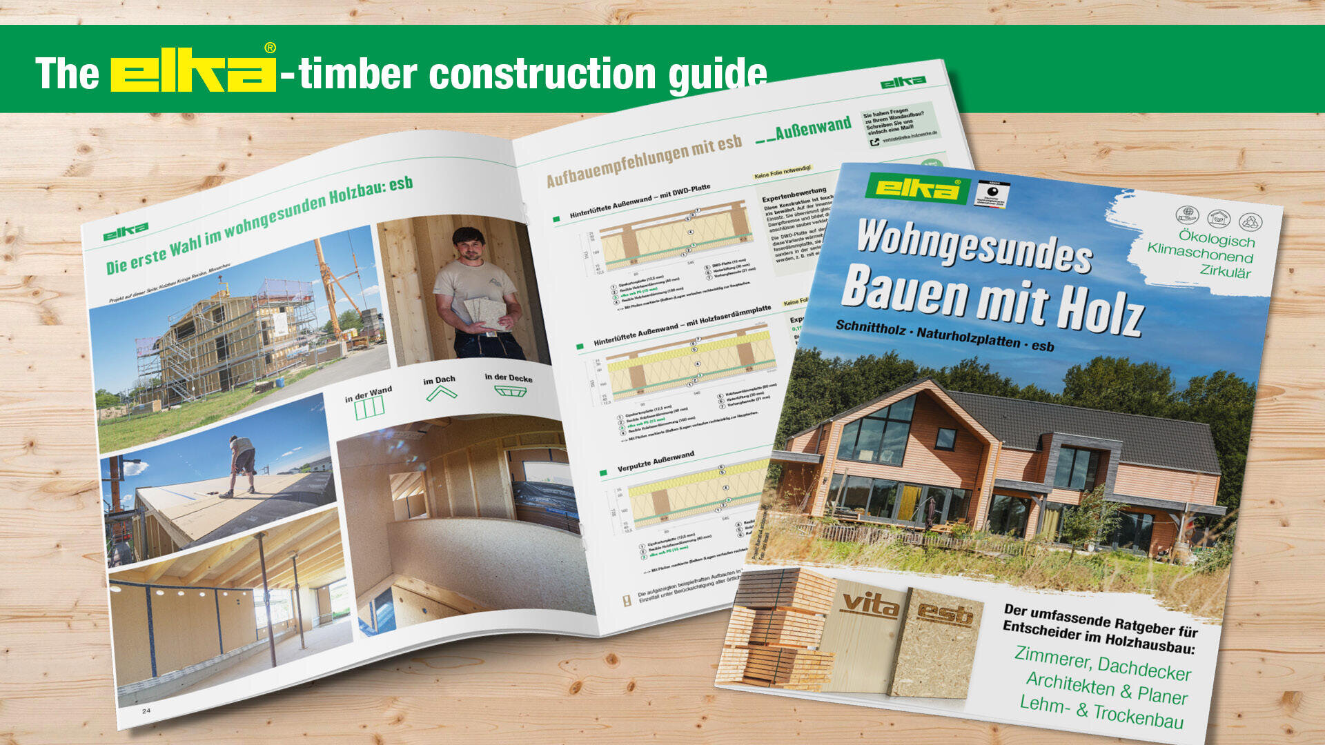 An open timber construction guide and a cover page of elka Wohngesundes Bauen mit Holz magazine with images of wooden houses, construction diagrams, and green headers on a wooden surface.