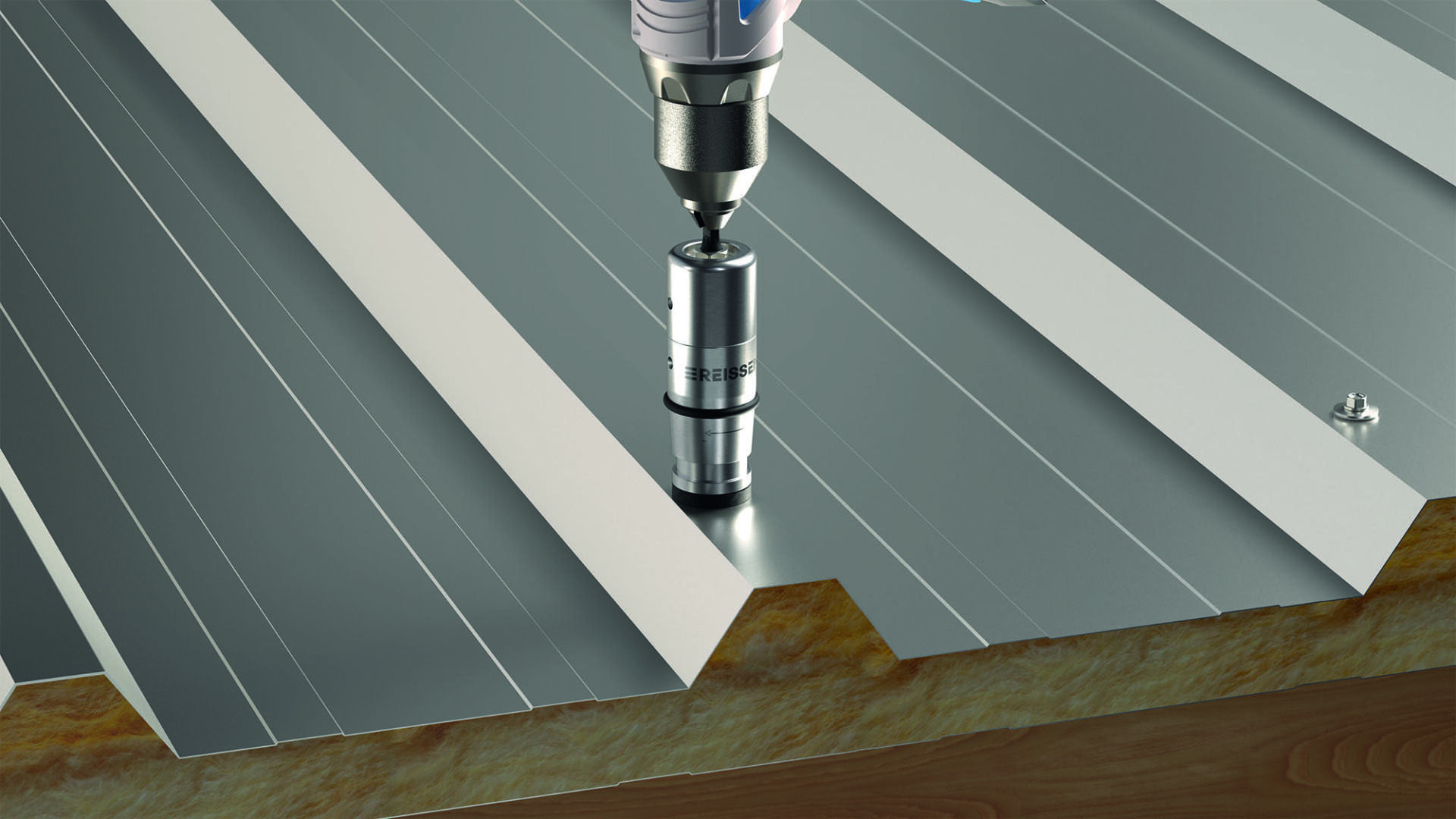 Close-up of a drill driving a screw into a corrugated metal roof attached to the insulation below. The scene shows the installation process.